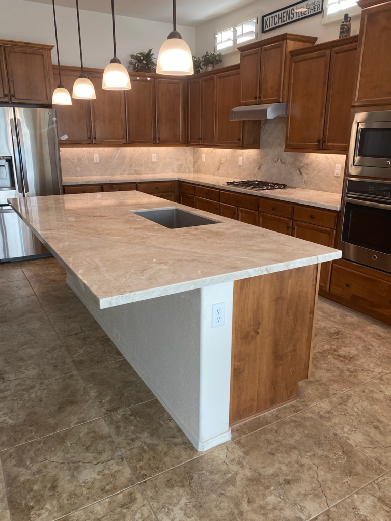 Best kitchen countertops Phoenix AZ island with wood cabinets and stone backsplash